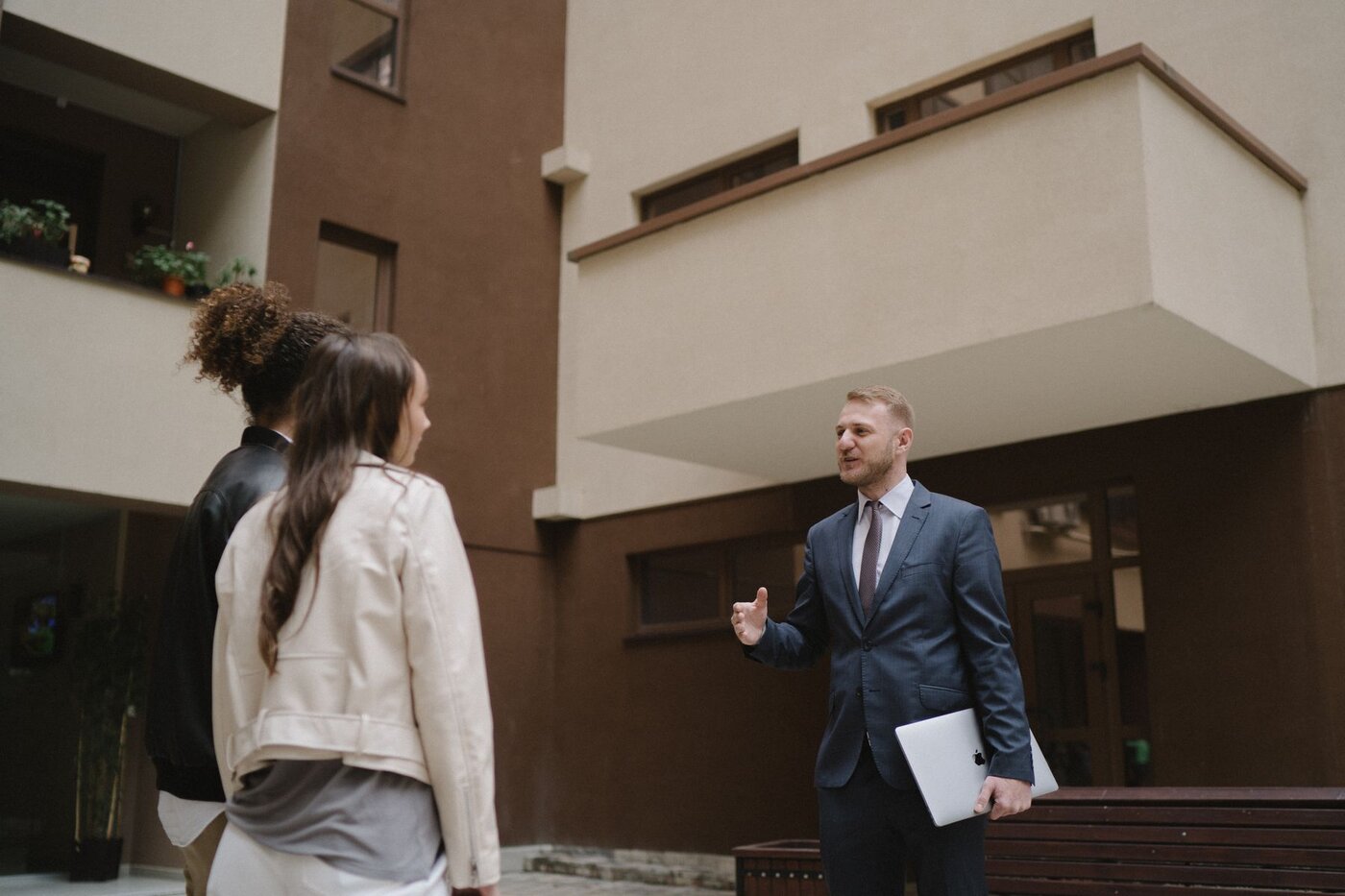 An adviser discussing a property with prospective buyers during an illustrative viewing