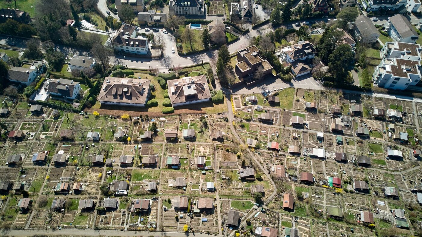 Aerial view of residential homes and green spaces, illustrating neighbourhood research