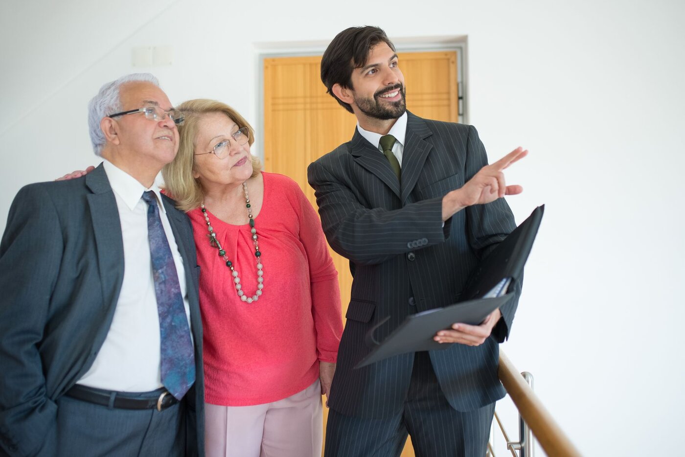 A couple discussing a property with an estate agent during an illustrative viewing