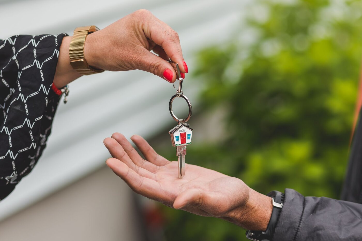 A house key being handed over, illustrating the distinction between an agreed sale and completion